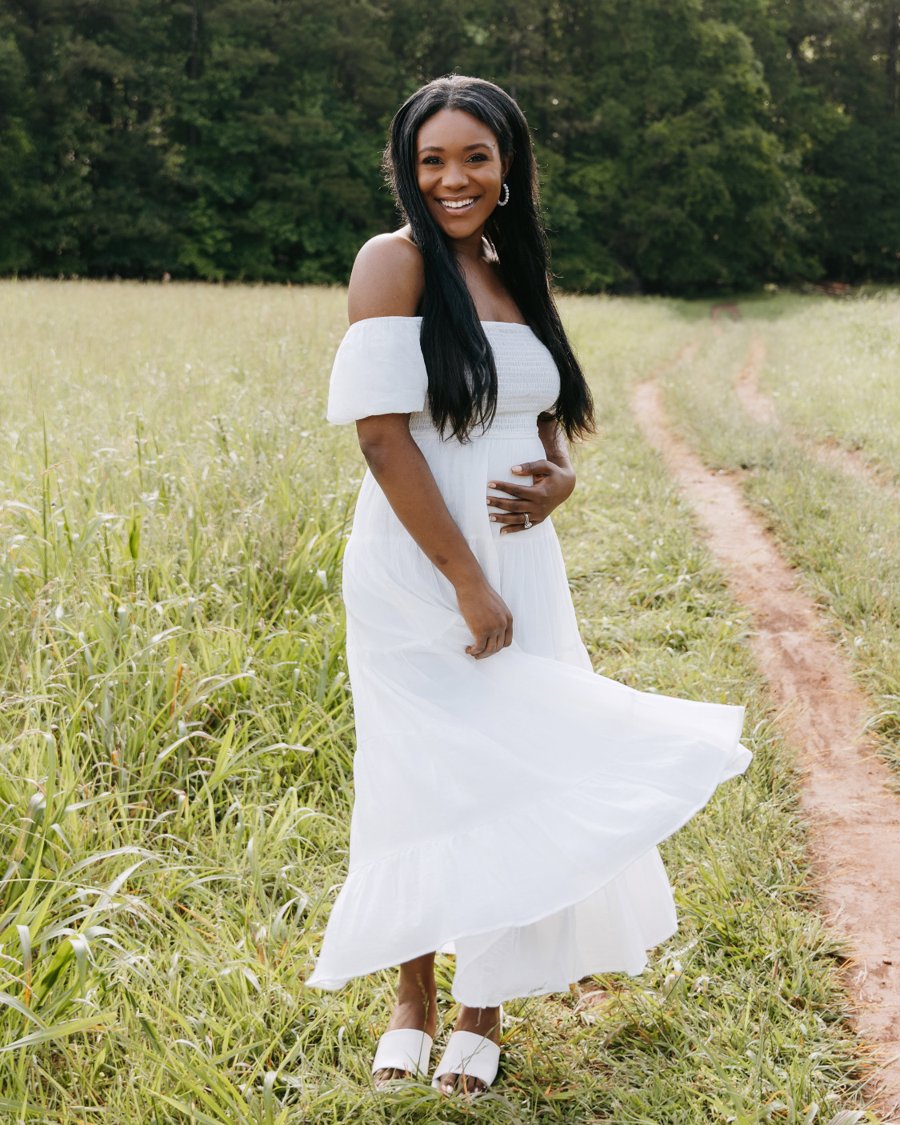 Rose smiling in a white dress in a sunny field
